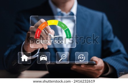 Credit score concept, Businessman use tablet with virtual credit score icon for chart with credit history values. Online credit score ranking check. student loan, mortgage and payment cards.