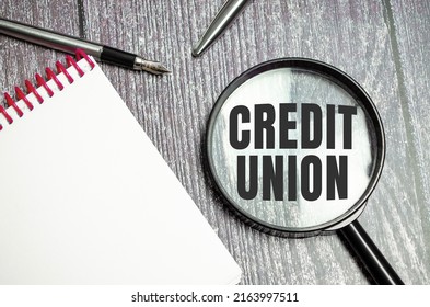 Credit Union. The Inscription On Magnifying Glass On Wooden Background