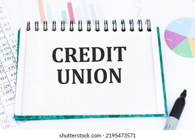 Credit Union Notepad Label On The Background Of Reports And Charts