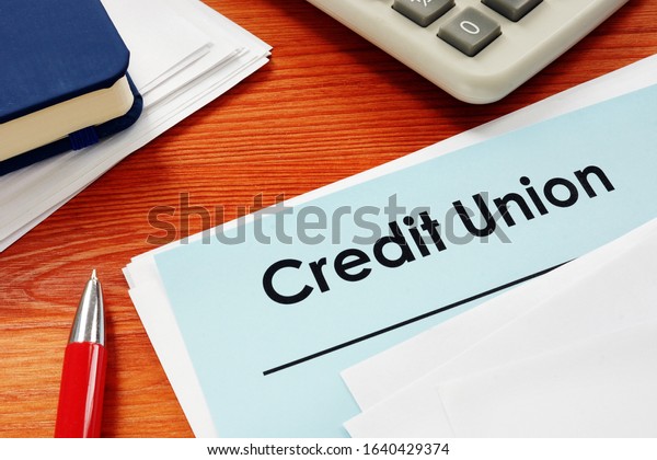 Credit Union papers for\
loan on desk.