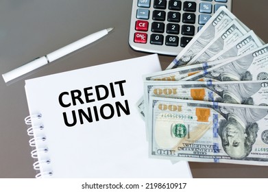 CREDIT UNION Text On The Blonde On The Table Next To The Calculator, Dollar Bills And Pen. Business Concept