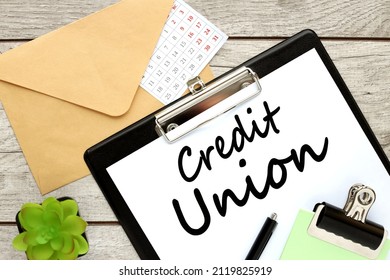 Credit Union Text On Notebook With Pen On Pink Background