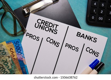 Credit Unions Vs Bank Text On Document Form Isolated On Office Desk. Pros And Cons
