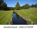 Creek in the palace garden of Egeskov Castle near Kvaerndrup, island of Funen, Denmark, Europe
