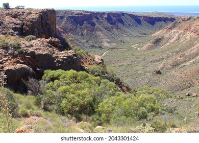 Creek Winding Through Valley To Ocean Surrounded By Plateaus. Nutrients Carried Down The Creeks To Ningarloo Reef Helps Spawn Coral Polyps And Krill, Which In Turn Feeds The Whale Sharks