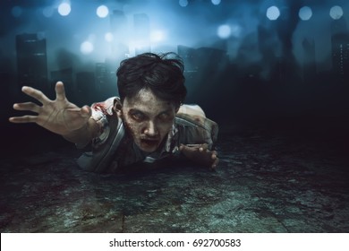 Creepy Asian Zombie Man Lying Down On With Wounded Face On The Dirty Floor