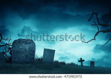 Creepy atmosphere in the cemetery with tombstone in the night, fog and trees that live twigs