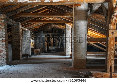 Creepy attic interior at abandoned industrial building