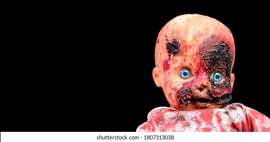 Creepy Bloody Doll Halloween Concept, Close Up Of Children Ghost Mystic Doll, Scary Horror Doll Face Isolated On Black Background.