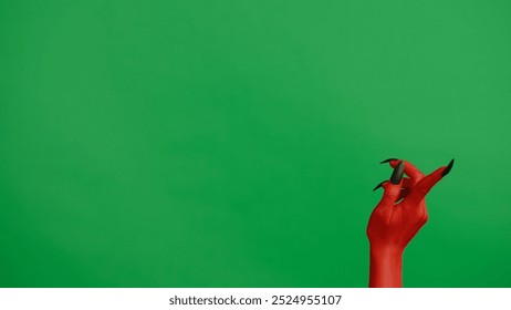 Creepy halloween devil monster hand in red paint with black nails pointing finger up, isolated on chroma key green screen background, workspace mockup. - Powered by Shutterstock