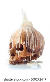 Creepy Image Of Skull With A Melting Candle On Top Isolated On White