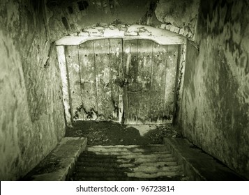 Creepy Looking Grunge Basement Door With Stairs