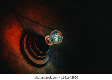 Creepy muddy lightbulb in the cellar of an old abandoned house or a mental hospital. Horror movie concept with copy space