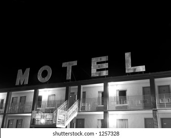 A Creepy Old Motel Sign In Black And White.