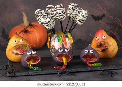 Creepy Pear And Fig Monsters, Mummy Shaped Chocolate Cake Pops And Gummy Worms For Halloween Party