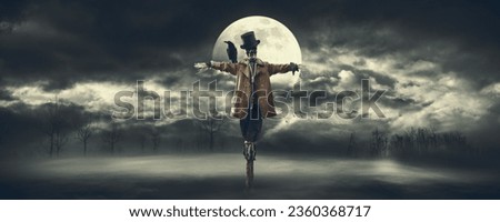Creepy scarecrow with crow on his shoulder and full moon in the night sky, horror and Halloween concept