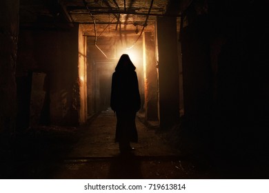 Creepy Silhouette In The Dark Abandoned Building. Horror About Maniac Concept  