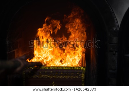 Cremate death people on fire flame burning on dark background, red and orange flame glowing, cremation ceremony concept, religion tradition of people, burning death people on hot bonfire