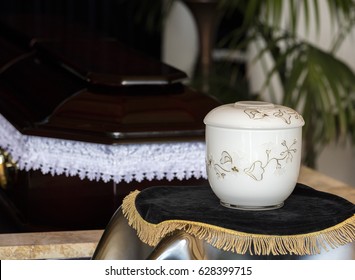 Cremation Urn In Front Of Coffin,