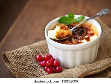 Creme brulee (cream brulee, burnt cream) with red currant and mint