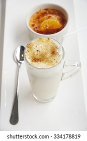 Creme Brulee Dessert,Cold Cafe Latte In Long Glass On White Plate .creme Brulee In Ceramic Bowl On White Plate