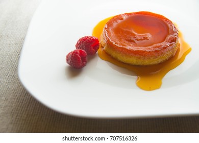 Creme brulee with raspberry.
