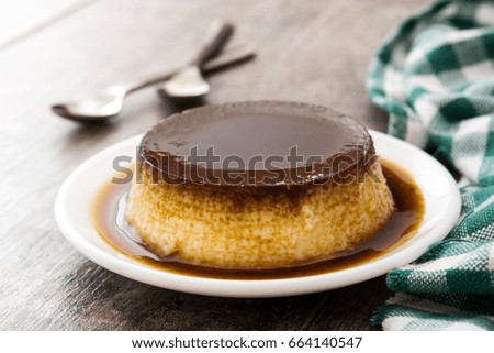 Creme caramel. Egg pudding on wooden background