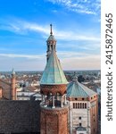 Cremona panorama of the cathedral bell tower from the Torrazzo tower at sunset. High quality photo