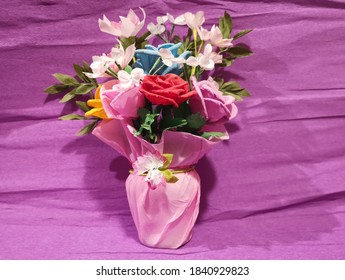 Crepe Paper Flowers On The Purple Background. 