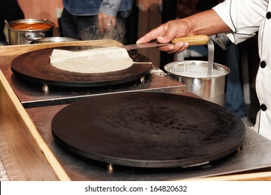 Creperie buffet with a chef preparing a crepe (pancake)  - Powered by Shutterstock