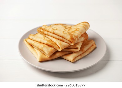 Crepes (Russian Blini) on white wooden background,. Homemade thin fresh crepes for breakfast or dessert.