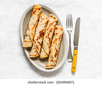 Crepes Stuffed With Tuna, Avocado And Egg On A Light Background, Top View          