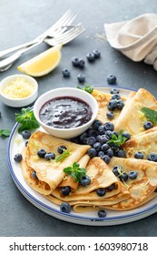 Crepes, Thin Pancakes With Blueberry Jam And Fresh Berries With Lemon Zest