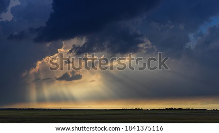 Crepuscular rays breaking through the clouds in Texas