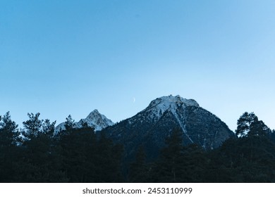 Crescent moon among snowy mountains  - Powered by Shutterstock