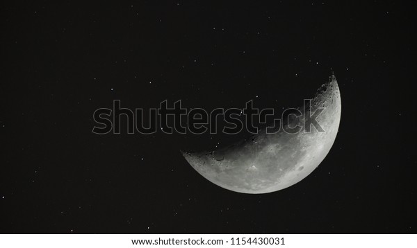 Crescent Moon background / The Moon is an\
astronomical body that orbits planet Earth and is Earth\'s only\
permanent natural satellite. It is the fifth-largest natural\
satellite in the Solar\
System