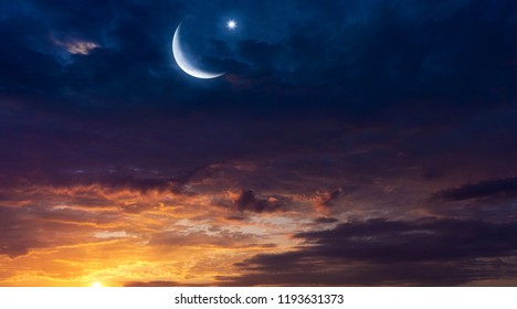 Crescent moon with beautiful sunset background . Light from sky . Religion background . beautiful sky . Yellow and pink clouds . Sunset and new moon . Prayer time . Generous Ramadan