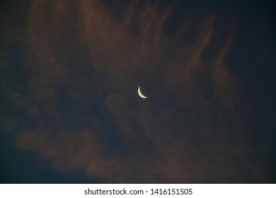 Crescent moon with cloudy sky before sunrise - Powered by Shutterstock