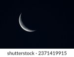 Crescent moon in the dark blue night sky, natural background.