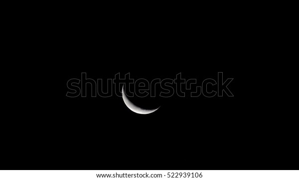 Crescent moon in darkness\
night.