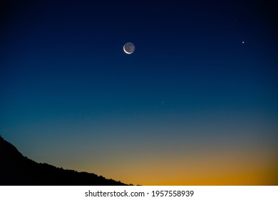 Crescent moon with earthshine and Venus rise with the mornings twilight in the desert.. - Powered by Shutterstock