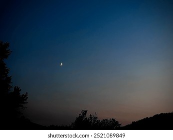 Crescent moon in night sky 