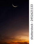 Crescent moon on dusk sky vertical on twilight well space for text Eid Al Adha,   