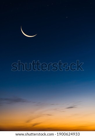 Crescent Moon on Twilight Sky in Evening Vertical with colorful sunlight after sundown,symbol Islamic Religion Ramadan, Dusk sky space background well for Arabic text present Eid al Adha, Eid al fitr.