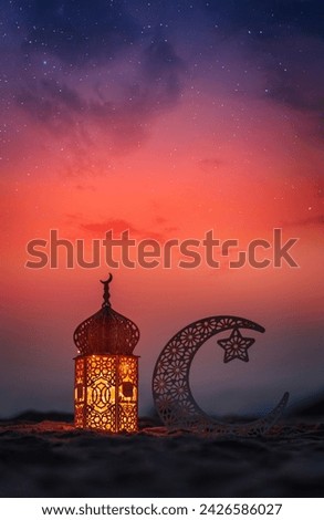Crescent moon shape and lantern lamp on the beach with dramatic sky on the background, Ramadan Kareem and Eid Mubarak concept background