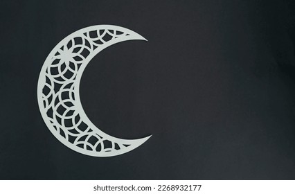 Crescent moon shape on a dark colour background, Arabic pattern image