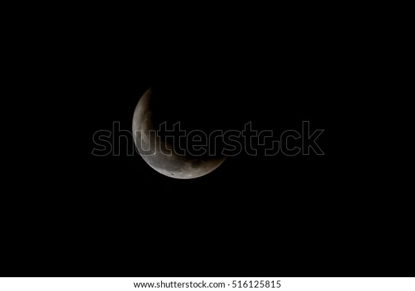 Crescent moon from some shadow on clear black sky at\
night time
