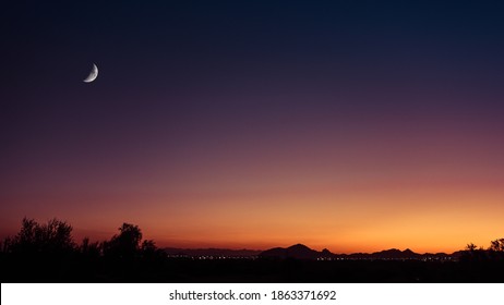 Crescent Moon At Sunset Over Camelback Mountain In Phoenix, Arizona