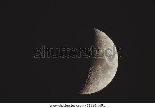 Crescent of\
the new moon on background of black\
sky.