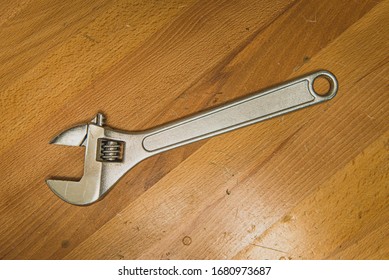 Crescent Wrench On Wood Work Bench Overhead View